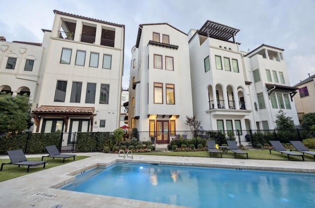5314 Paseo Caceres Dr, Houston, TX 77007 - rear view of house featuring french doors, stucco siding, and a community pool