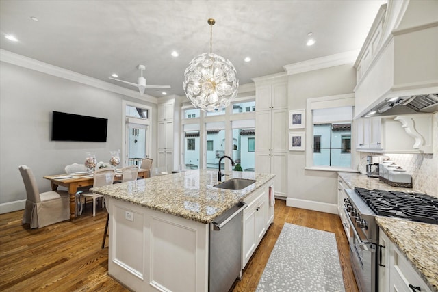 5314 Paseo Caceres Dr, Houston, TX 77007 - kitchen with appliances with stainless steel finishes, a sink, recessed lighting, white cabinetry, and a kitchen island with sink