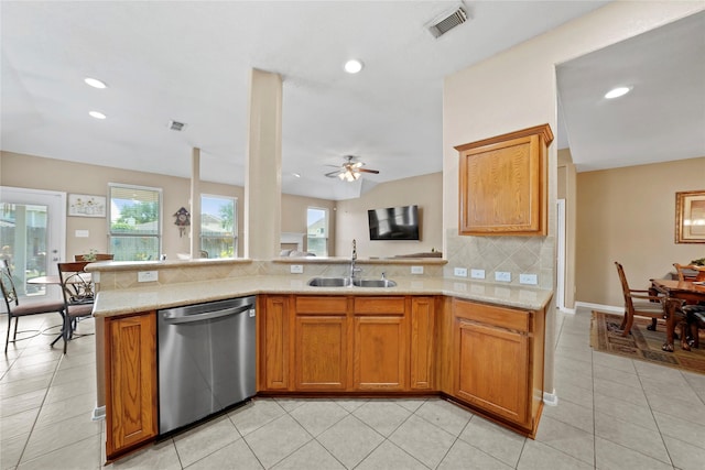 8630 Kirksage Dr, Houston, TX 77089 - kitchen featuring stainless steel dishwasher, a sink, backsplash, brown cabinets, and recessed lighting