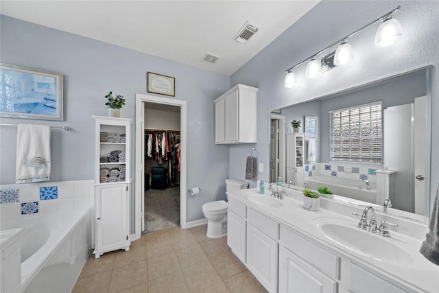 8630 Kirksage Dr, Houston, TX 77089 - full bathroom featuring a garden tub, tile patterned floors, toilet, double vanity, and a spacious closet