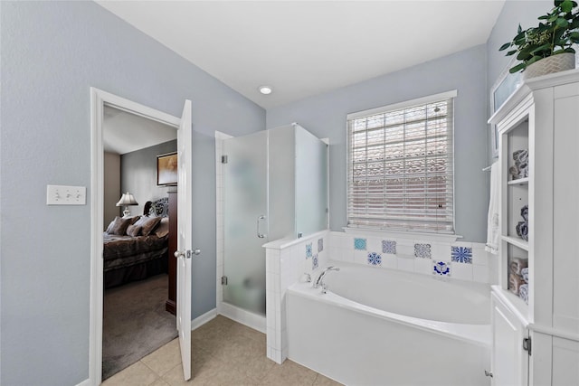 8630 Kirksage Dr, Houston, TX 77089 - ensuite bathroom with a stall shower, tile patterned flooring, a bath, and baseboards