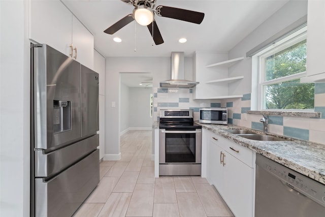5006 Lymbar Dr, Houston, TX 77096 - kitchen featuring stainless steel appliances, wall chimney exhaust hood, a sink, tasteful backsplash, and white cabinetry