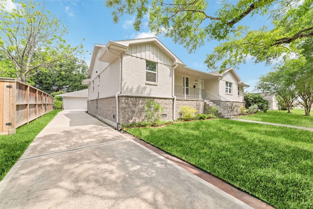 5006 Lymbar Dr, Houston, TX 77096 - ranch-style house with board and batten siding, a front yard, brick siding, and stairs