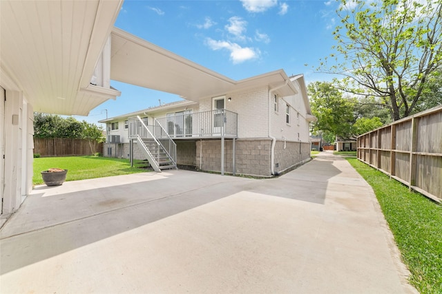 5006 Lymbar Dr, Houston, TX 77096 - view of side of home with brick siding, stairway, a patio area, and a deck
