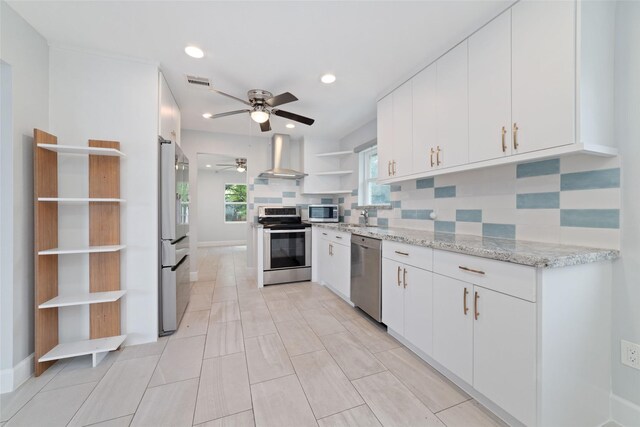 5006 Lymbar Dr, Houston, TX 77096 - kitchen with stainless steel appliances, open shelves, wall chimney exhaust hood, a ceiling fan, and decorative backsplash