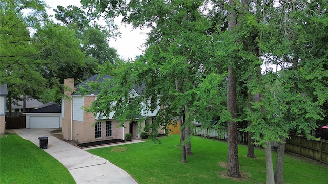 25014 Rettendon Ct, Spring, TX 77389 - view of front of house featuring concrete driveway, a chimney, an outdoor structure, and brick siding