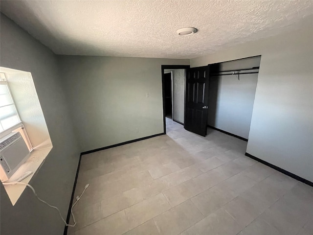 745 Yorkshire St, Houston, TX 77022 - unfurnished bedroom with baseboards, a textured ceiling, a closet, and cooling unit