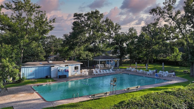 7222 Hartland Ave, Houston, TX 77055 - pool at dusk with a gazebo, a patio area, a community pool, and view of wooded area