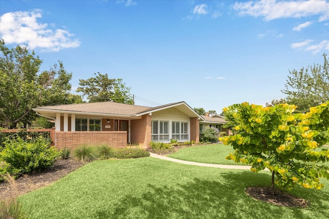 7222 Hartland Ave, Houston, TX 77055 - ranch-style house featuring brick siding and a front lawn