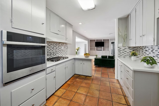 7222 Hartland Ave, Houston, TX 77055 - kitchen with appliances with stainless steel finishes, backsplash, light countertops, and recessed lighting