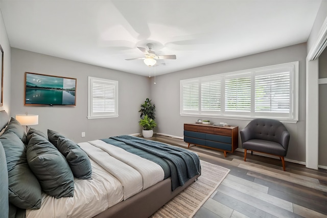 7222 Hartland Ave, Houston, TX 77055 - bedroom featuring multiple windows, wood finished floors, ceiling fan, and baseboards
