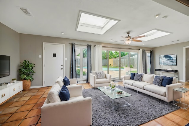 7222 Hartland Ave, Houston, TX 77055 - living area featuring a skylight, a ceiling fan, baseboards, and tile patterned flooring