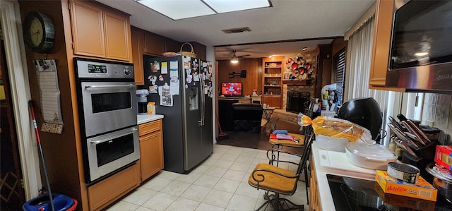 15459 Runswick Dr, Houston, TX 77062 - kitchen with appliances with stainless steel finishes, light tile patterned floors, open floor plan, ceiling fan, and built in shelves