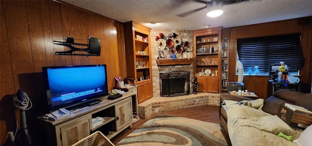 15459 Runswick Dr, Houston, TX 77062 - living area with wooden walls, a textured ceiling, ceiling fan, a brick fireplace, and built in features