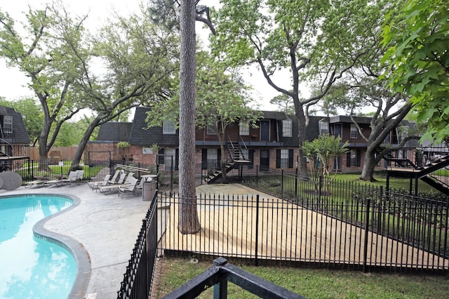 9005 Gaylord St Unit 20, Houston, TX 77024 - community pool with a patio area, stairway, and a residential view