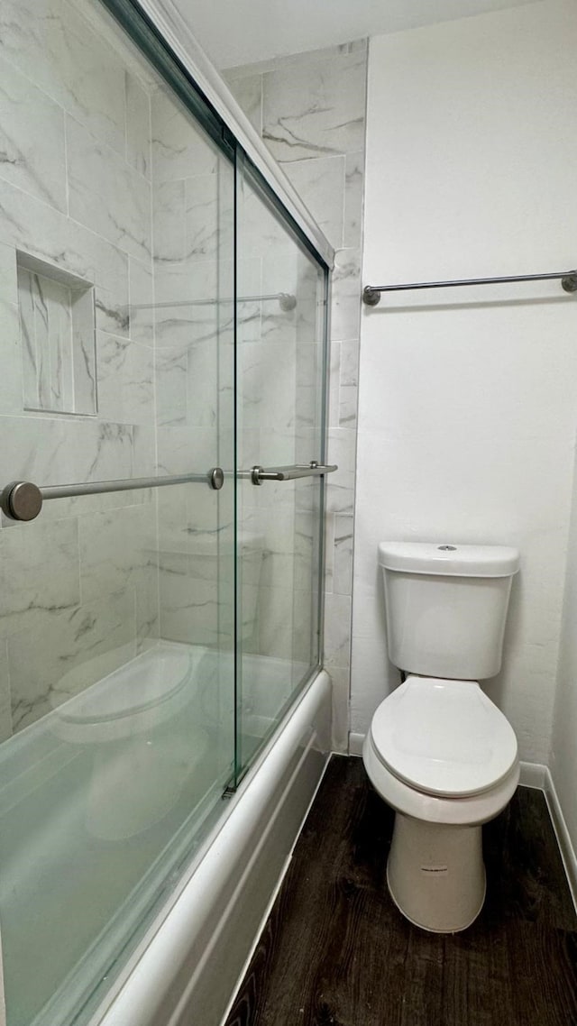 9005 Gaylord St Unit 20, Houston, TX 77024 - bathroom with toilet and combined bath / shower with glass door