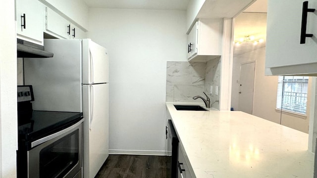 9005 Gaylord St Unit 20, Houston, TX 77024 - kitchen featuring stainless steel electric range oven, exhaust hood, dark wood-type flooring, and white cabinets