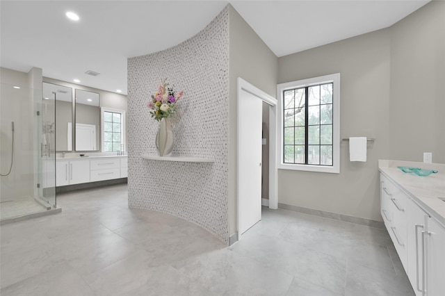 bathroom featuring vanity, a shower stall, baseboards, and recessed lighting