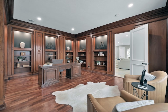 office area featuring ornamental molding, dark wood finished floors, recessed lighting, and built in features
