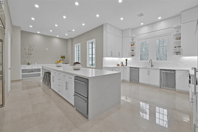 kitchen with stainless steel dishwasher, open shelves, a large island, white cabinetry, and recessed lighting