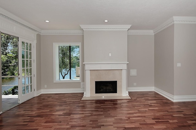 unfurnished living room featuring wood finished floors, plenty of natural light, crown molding, baseboards, and recessed lighting