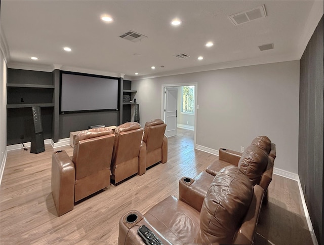 home theater with ornamental molding, baseboards, recessed lighting, and light wood-style flooring
