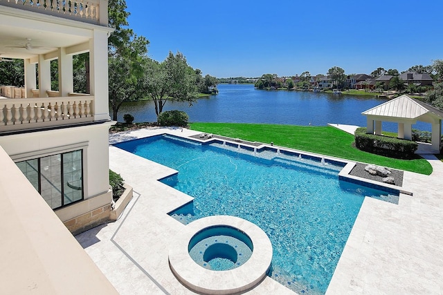 view of pool with a water view, a gazebo, a lawn, a ceiling fan, and a pool with connected hot tub