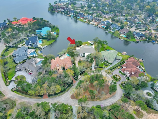 aerial view of property and surrounding area featuring nearby suburban area and a nearby body of water