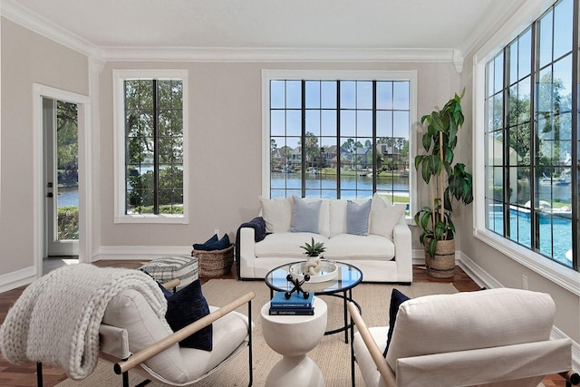 sunroom featuring a water view