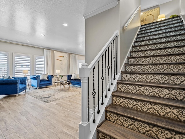 441 Jeanie Lynn St, Galveston, TX 77554 - stairs featuring wood finished floors, a textured ceiling, and recessed lighting