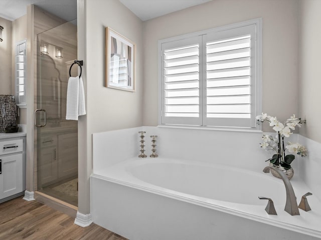 441 Jeanie Lynn St, Galveston, TX 77554 - bathroom with a shower stall, a bath, wood finished floors, and vanity