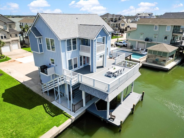 441 Jeanie Lynn St, Galveston, TX 77554 - back of house featuring board and batten siding, a shingled roof, a residential view, and a water view
