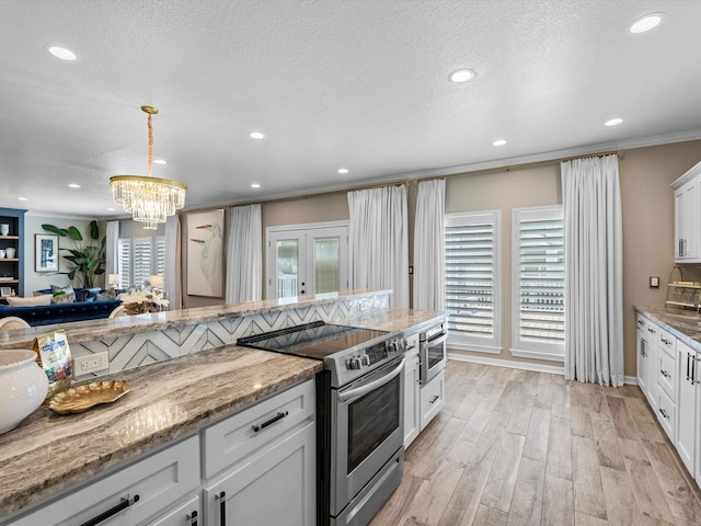 441 Jeanie Lynn St, Galveston, TX 77554 - kitchen with appliances with stainless steel finishes, a chandelier, recessed lighting, pendant lighting, and crown molding