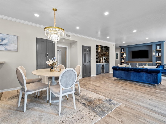 441 Jeanie Lynn St, Galveston, TX 77554 - dining area with a chandelier, baseboards, light wood finished floors, crown molding, and recessed lighting