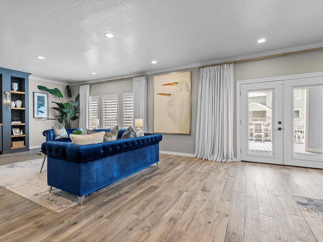 441 Jeanie Lynn St, Galveston, TX 77554 - living area featuring crown molding, french doors, wood finished floors, a textured ceiling, and baseboards