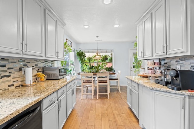 9519 Territory Ln, Houston, TX 77064 - kitchen featuring stainless steel microwave, dishwasher, backsplash, light wood-style floors, and healthy amount of natural light