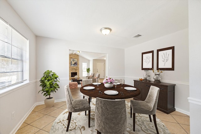 5519 Fallengate Dr, Spring, TX 77373 - dining area featuring light tile patterned floors, a fireplace, and baseboards