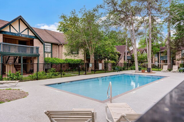 8229 Kingsbrook Rd Unit 229, Houston, TX 77024 - community pool with fence and a patio area