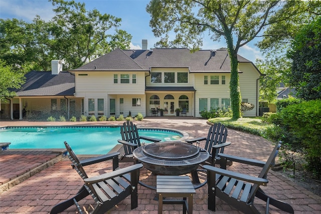 2203 Long Valley Dr, Kingwood, TX 77345 - outdoor pool featuring a patio area and an outdoor fire pit