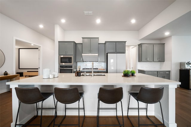 1682 Sherwood Glen Dr, Friendswood, TX 77546 - kitchen featuring refrigerator, oven, built in microwave, gray cabinetry, and a spacious island