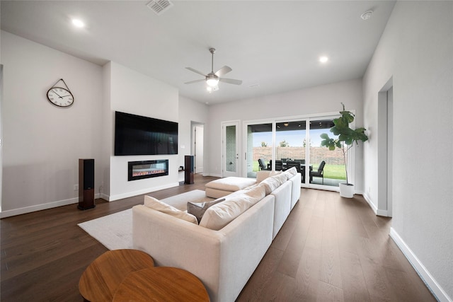 1682 Sherwood Glen Dr, Friendswood, TX 77546 - living room featuring ceiling fan, dark wood-style flooring, a glass covered fireplace, baseboards, and recessed lighting