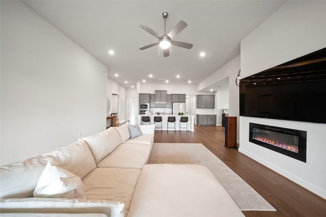 1682 Sherwood Glen Dr, Friendswood, TX 77546 - living room with ceiling fan, dark wood-style flooring, and a glass covered fireplace