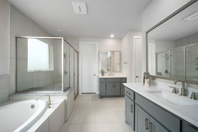 1682 Sherwood Glen Dr, Friendswood, TX 77546 - full bathroom with a stall shower, two vanities, a garden tub, tile patterned floors, and recessed lighting