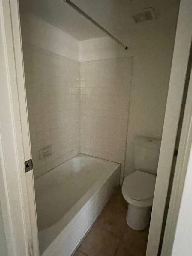 bathroom with tile patterned flooring, toilet, and bathtub / shower combination