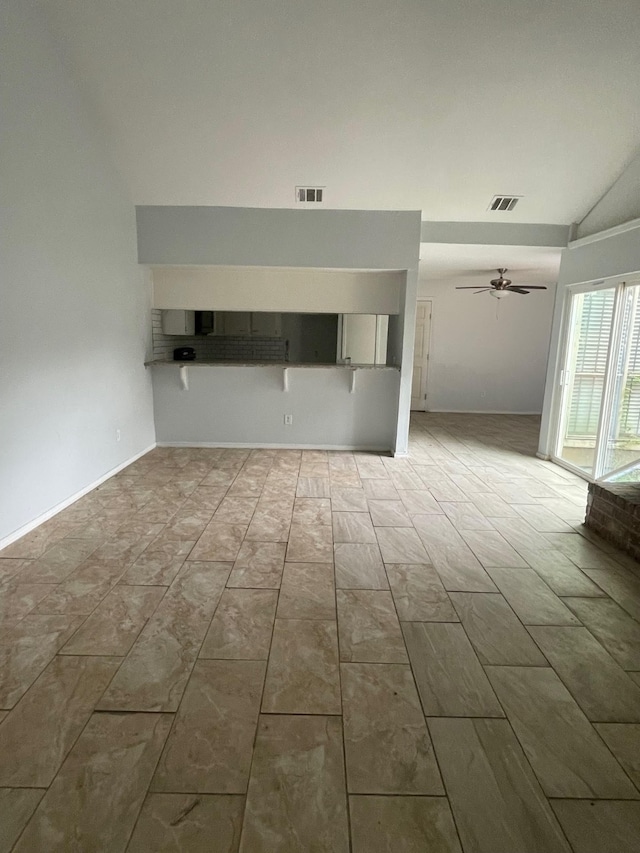 empty room featuring vaulted ceiling and ceiling fan