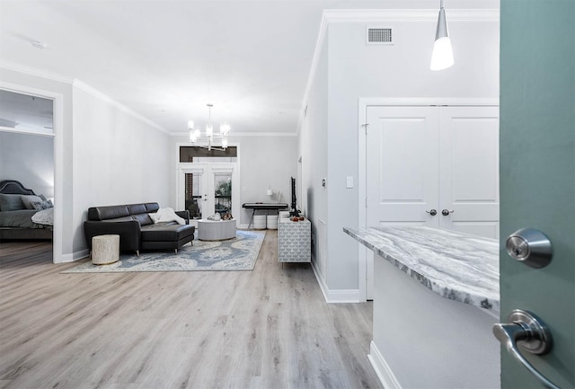 300 St Joseph Pkwy Unit 121, Houston, TX 77002 - living room with baseboards, light wood-style floors, a chandelier, crown molding, and french doors