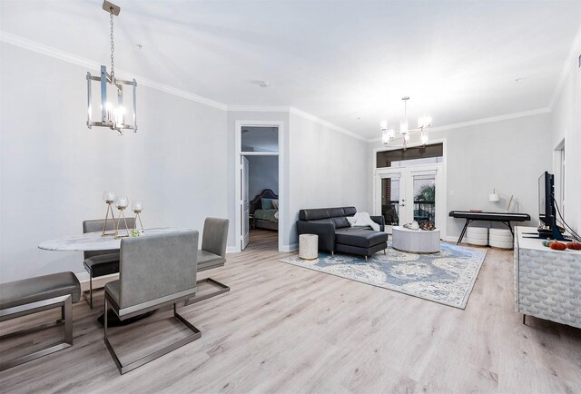 300 St Joseph Pkwy Unit 121, Houston, TX 77002 - dining space featuring a chandelier, wood finished floors, baseboards, ornamental molding, and french doors