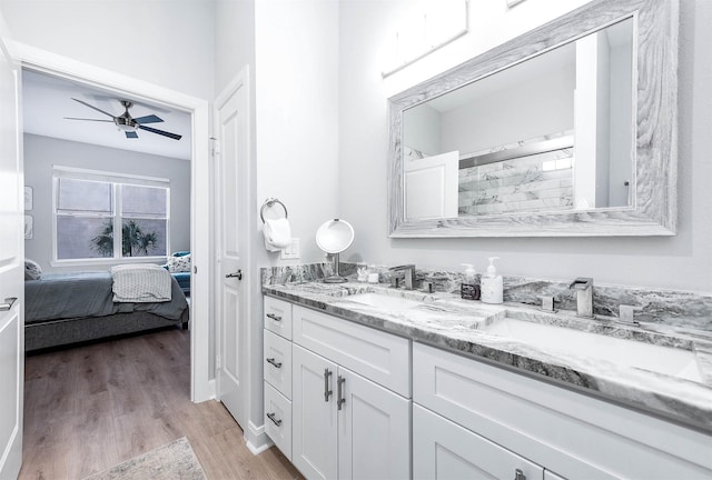 300 St Joseph Pkwy Unit 121, Houston, TX 77002 - ensuite bathroom featuring wood finished floors, ceiling fan, double vanity, and a shower