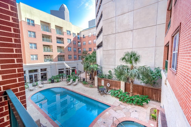 300 St Joseph Pkwy Unit 121, Houston, TX 77002 - community pool with a patio area and fence