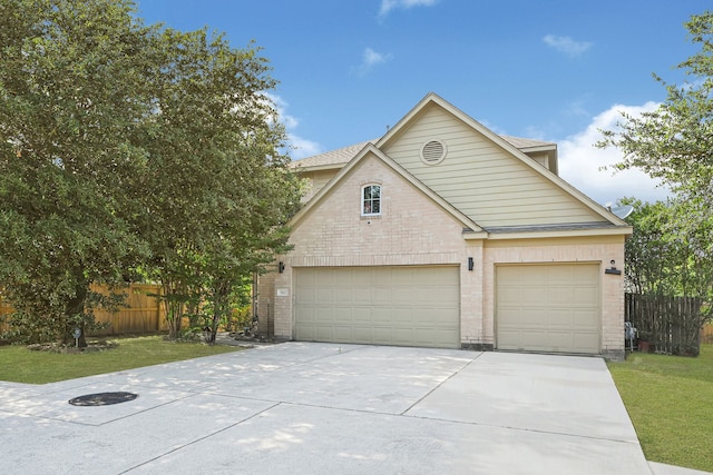 traditional-style home with driveway and brick siding